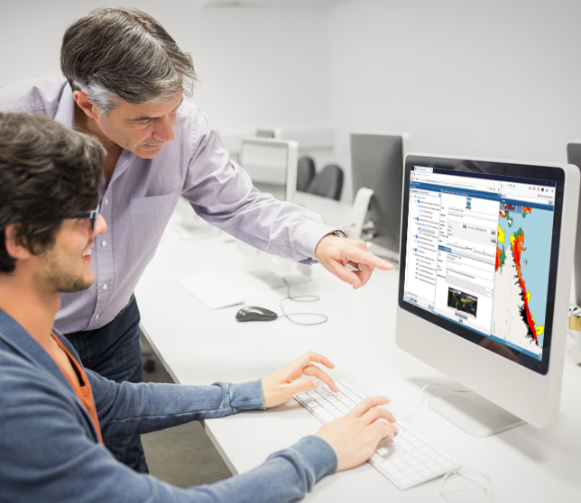 two men looking at WES on a computer