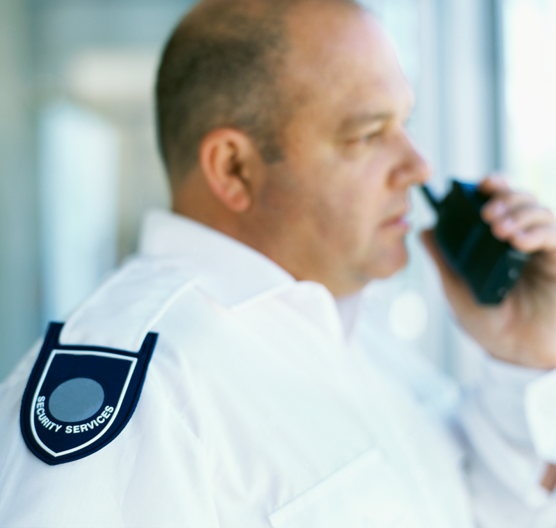 security officer talking on walkie talkie