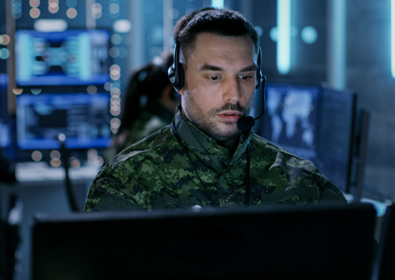 man in military in command room on computer